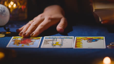 Close-Up-Of-Woman-Giving-Tarot-Card-Reading-On-Candlelit-Table-17